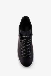 Alexander McQueen men’s low top black leather sneakers with white laces and contrasting white sole