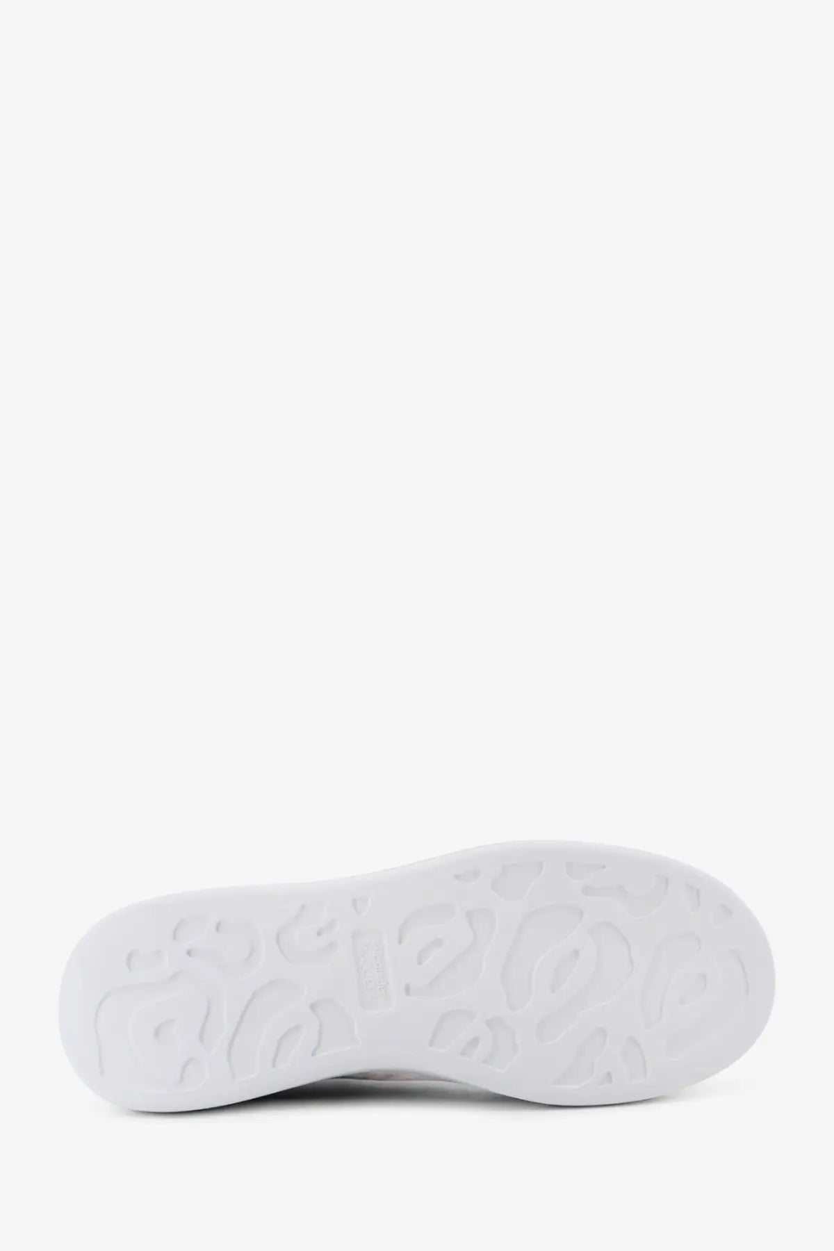 White rubber sole with embossed logo pattern on alexander mcqueen men’s low top black leather sneakers