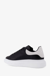 Alexander McQueen men’s low top black and white leather sneakers with chunky sole front view