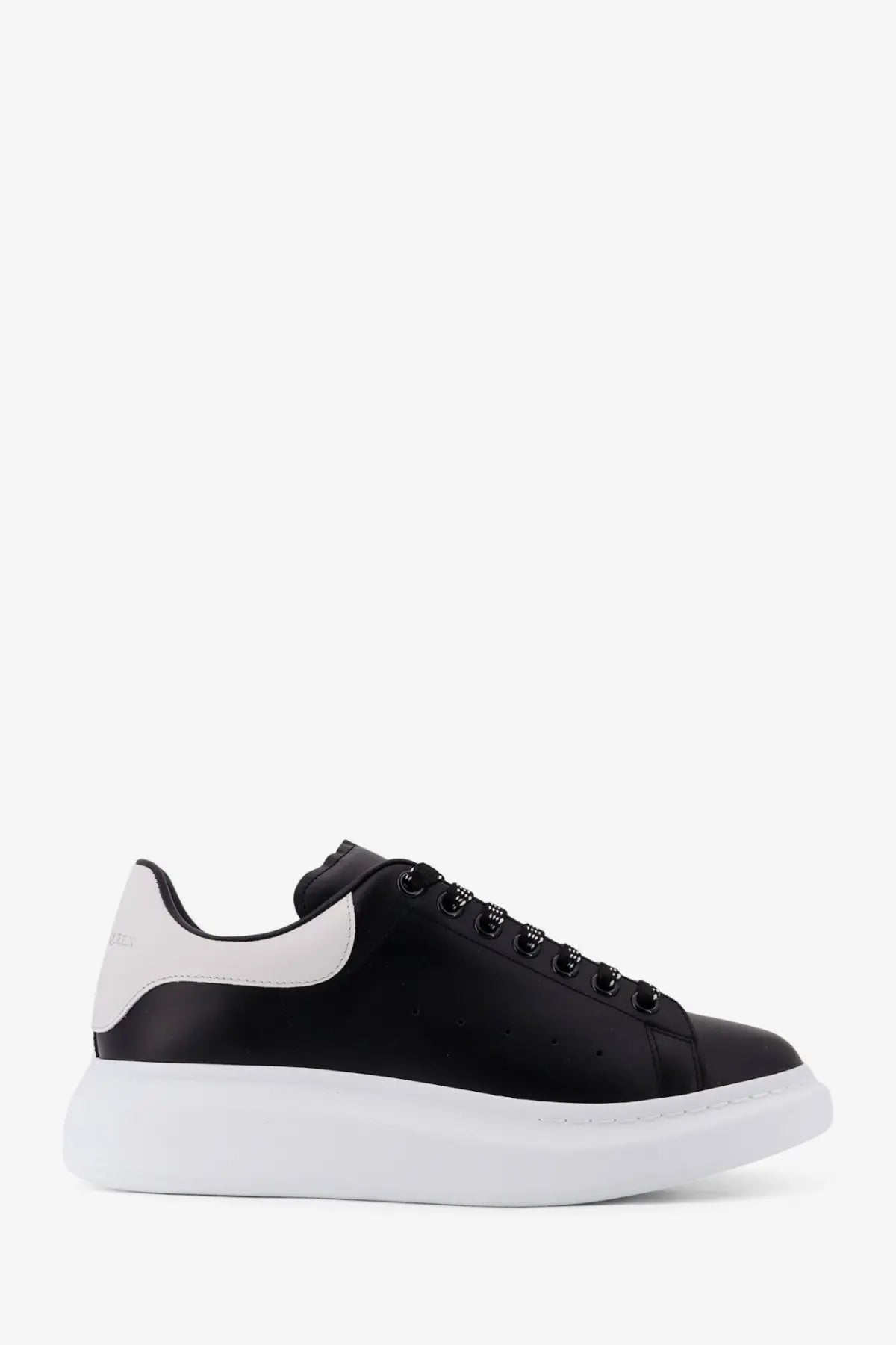 Alexander McQueen men’s low top leather sneakers in black and white with a chunky sole front view