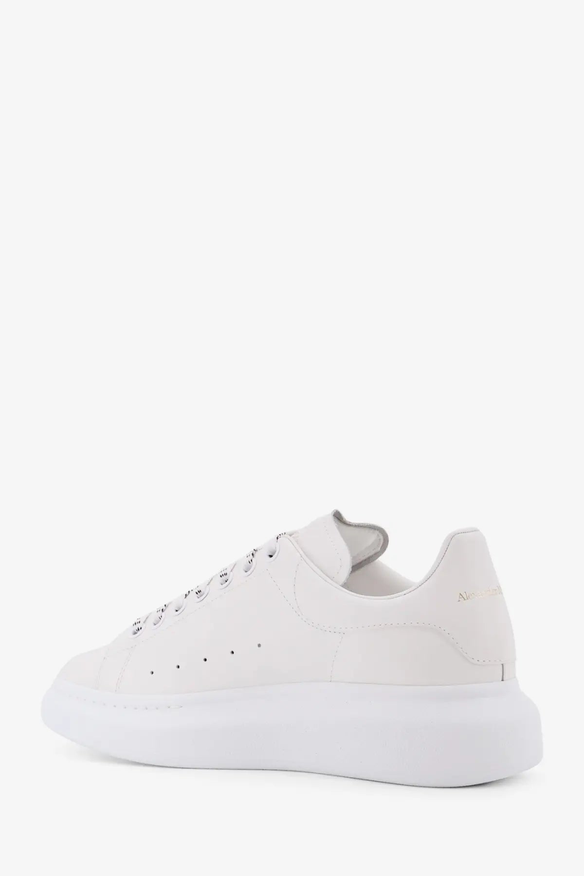 White leather alexander mcqueen men’s low top sneaker with chunky sole and subtle branding on the heel back view