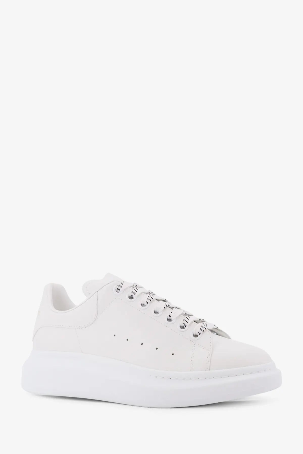 Alexander McQueen men’s white low top leather sneaker with chunky sole and perforated detailing