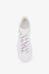 Alexander McQueen men’s low top white leather sneakers with black dotted laces for stylish casual wear