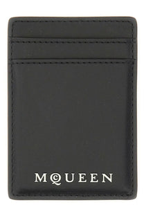 Black leather magnetic card holder for men by Alexander McQueen with white mcqueen logo at the bottom