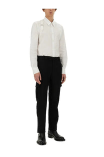 White long-sleeved button-up shirt with crisp collar and chest strap detail paired with alexander mcqueen black military pants
