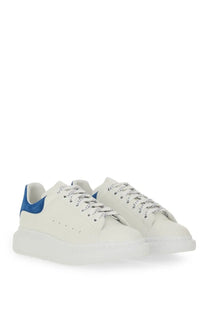 Alexander mcqueen men’s oversized white leather sneakers with bold blue heel tab and chunky white sole back view