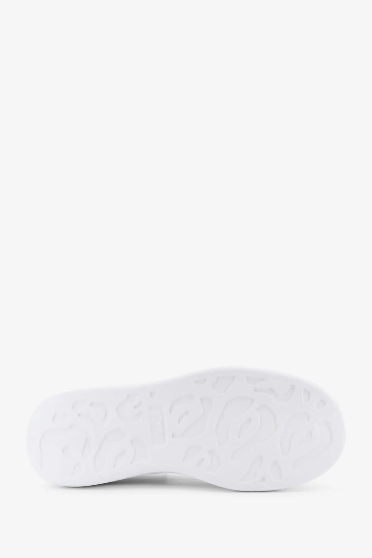 White rubber sole with embossed leopard print pattern on Alexander McQueen men’s oversized black leather sneakers