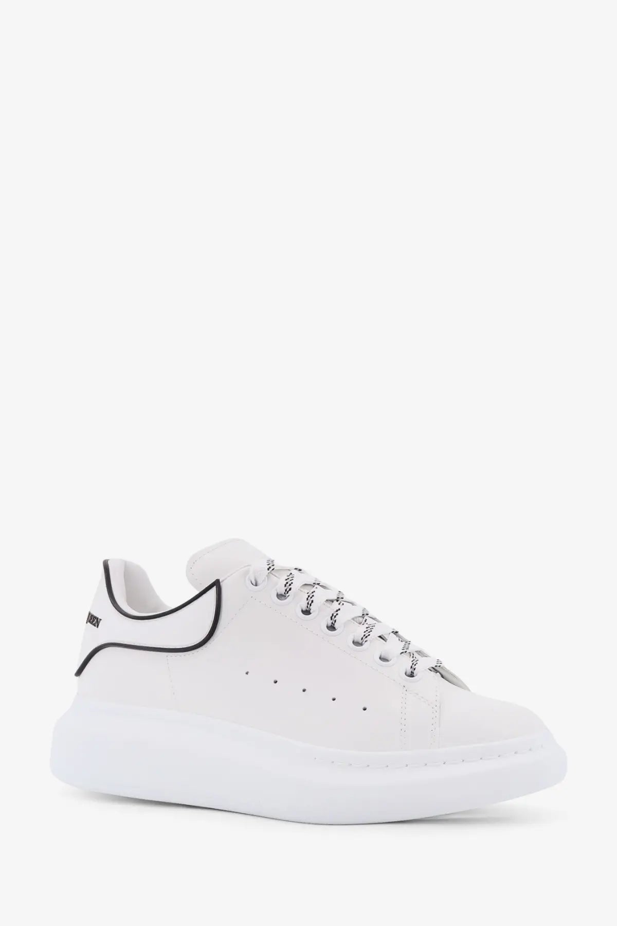 Alexander McQueen men’s oversized low top leather sneaker in white with black piping and textured laces
