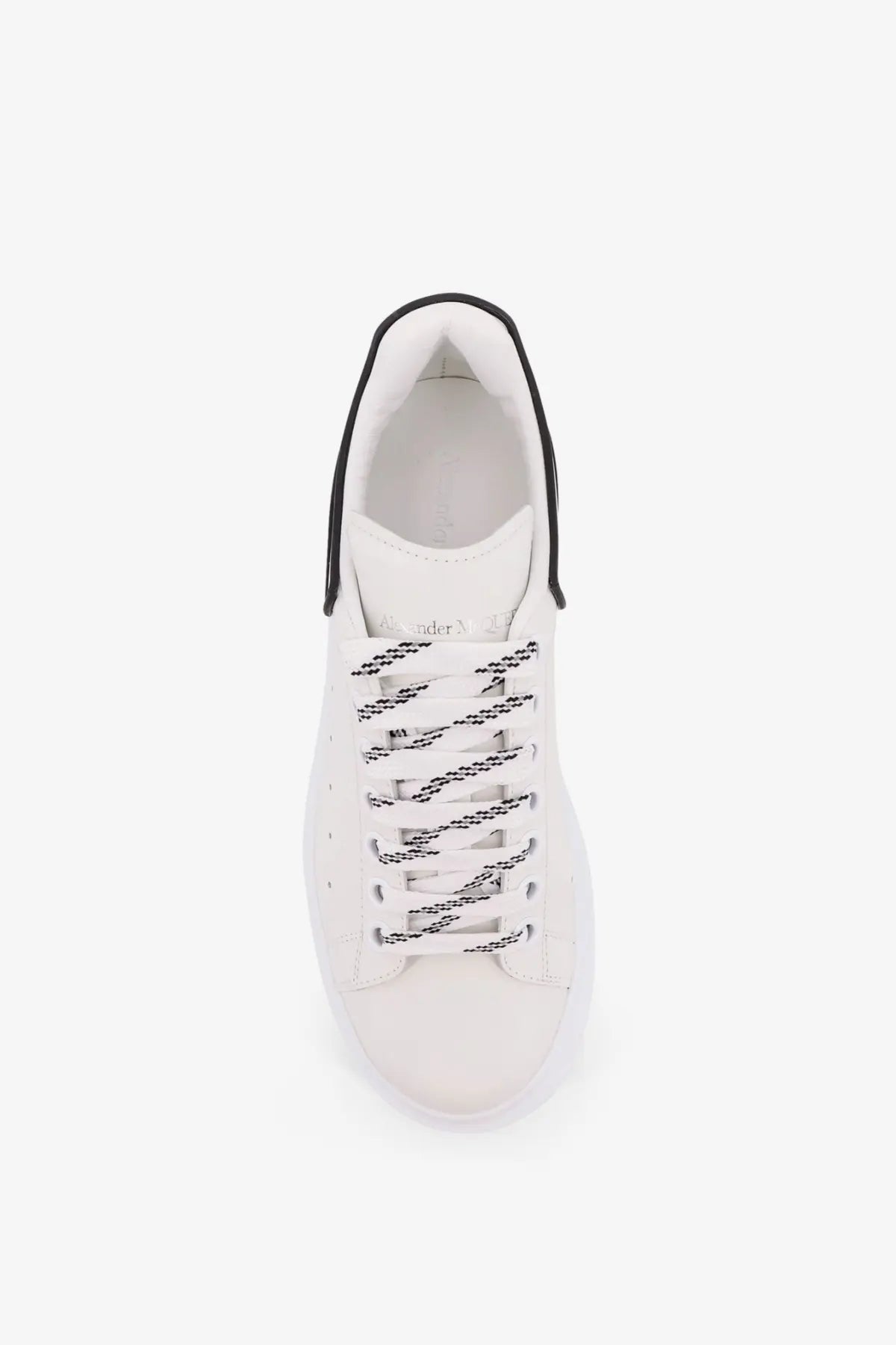 White leather alexander mcqueen men’s oversized low top sneaker with black laces and contrasting black collar trim