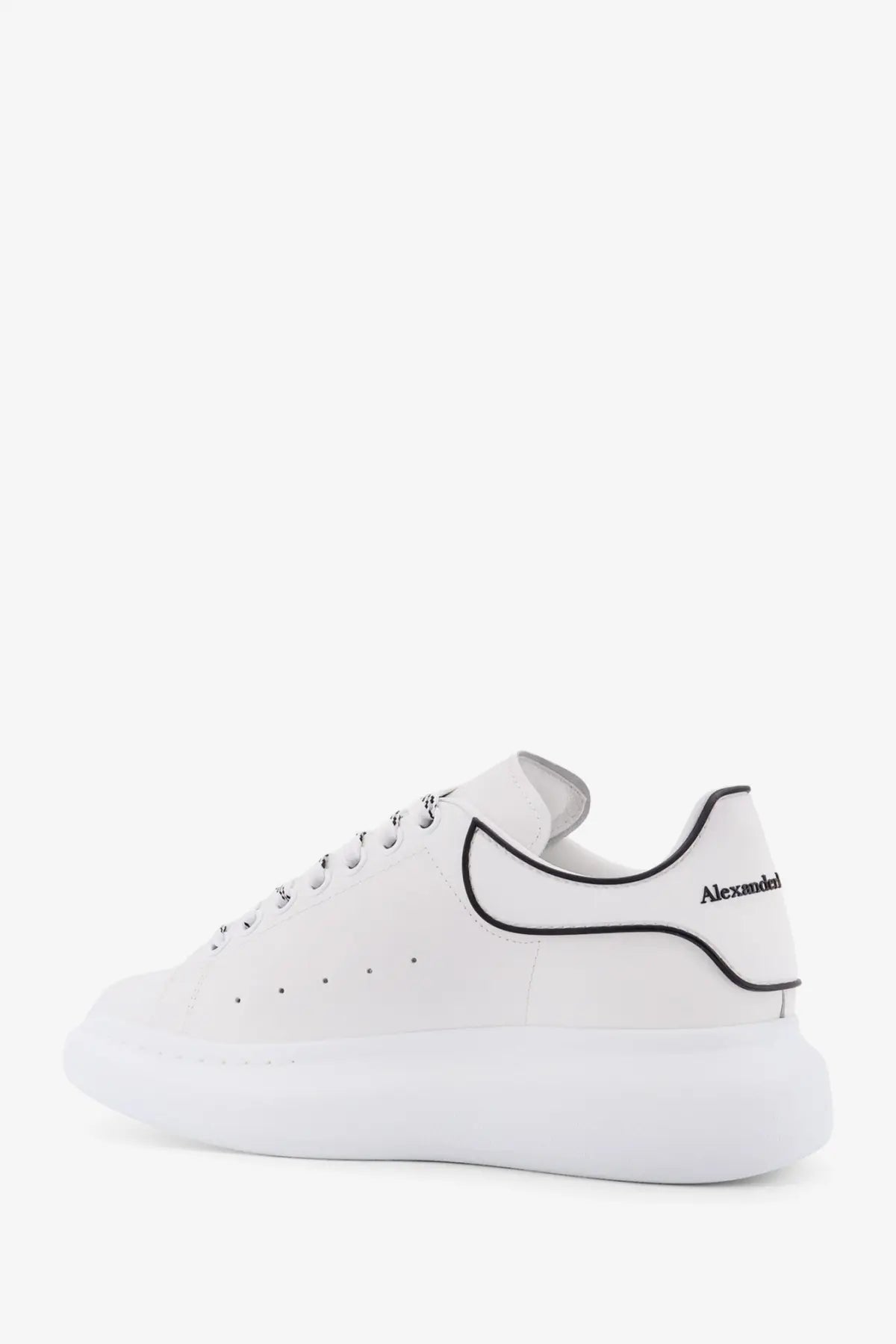 Back view of white leather alexander mcqueen men’s oversized low top sneaker with black piping and heel branding