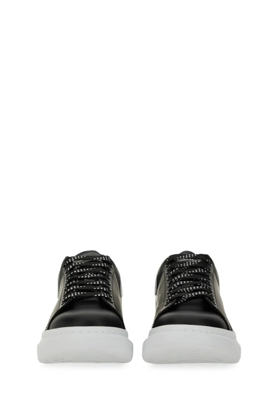 Alexander McQueen men’s oversized sneaker black leather with white rubber soles and patterned laces front view