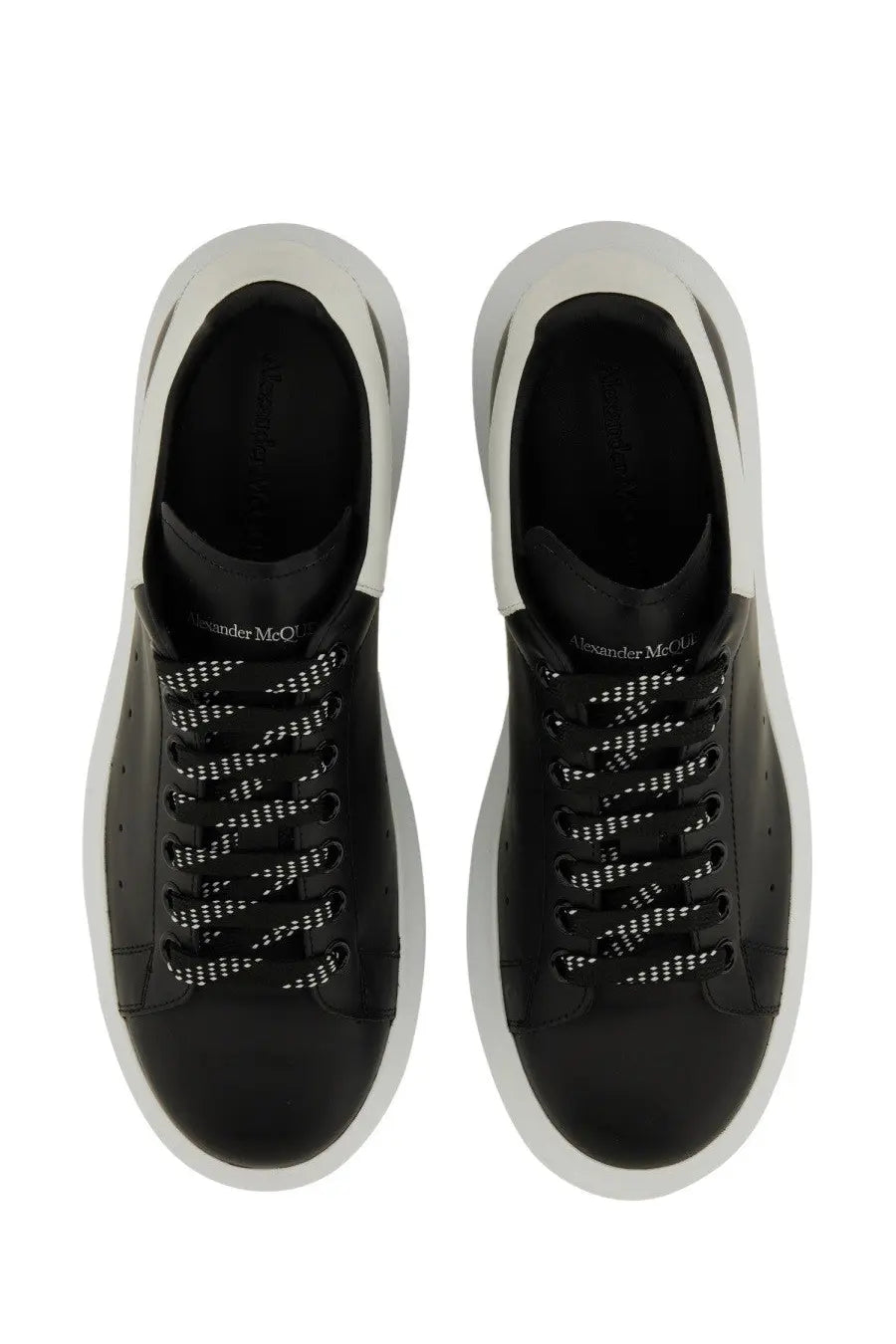 Alexander McQueen men’s oversized sneaker in black leather with white rubber soles and perforated detailing
