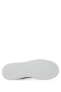 White rubber sole with embossed logo pattern on alexander mcqueen men’s oversized black sneaker back side