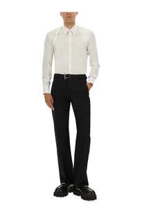 White long-sleeved button-down shirt with subtle structured detailing paired with alexander mcqueen black men’s pants