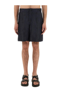 Alexander mcqueen men’s denim blue shorts with dark navy pleated fabric and buttoned waistband