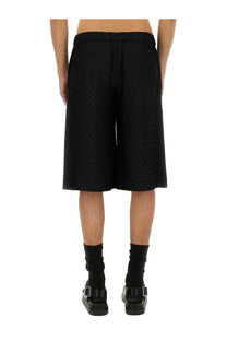 Alexander McQueen men’s black jacquard shorts with skull pattern textured fabric and elastic waistband