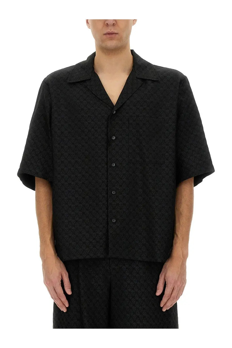 Alexander McQueen men’s black short-sleeved button-up shirt with subtle skull textured pattern and lightweight fabric
