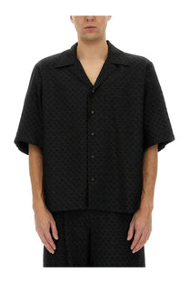 Alexander McQueen men’s black short-sleeved button-up shirt with subtle skull textured pattern and lightweight fabric