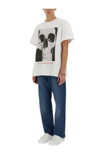 White alexander mcqueen men’s cotton tee featuring a bold skull graphic print on front