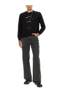 Alexander McQueen men’s black knit sweater with distressed lace-like skull design across the chest