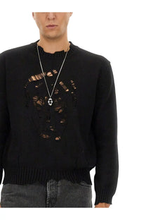 Black knit Alexander McQueen men’s sweater featuring a distressed ripped skull design across the chest