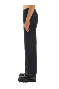 Alexander McQueen men’s dark indigo denim wide leg jeans with contrasting white stitching and straight leg cut