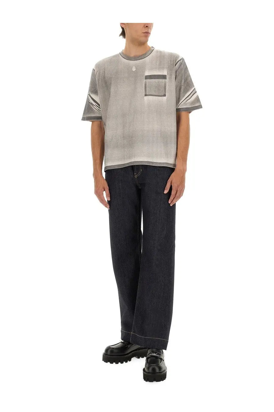 Gray gradient short-sleeve t-shirt with subtle pocket detail and ribbed cuffs paired with alexander mcqueen men’s wide leg jeans blue