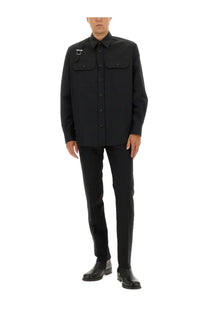 Black long-sleeved wool shirt with two chest pockets and silver logo patch paired with alexander mcqueen wool pants