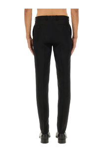 Black tailored wool trousers by Alexander McQueen with sleek straight-leg cut and subtle stitching details