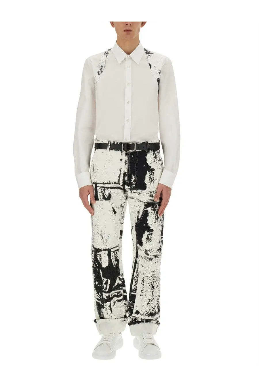 Alexander McQueen men’s white workwear jeans with black graffiti-like abstract distressed pattern