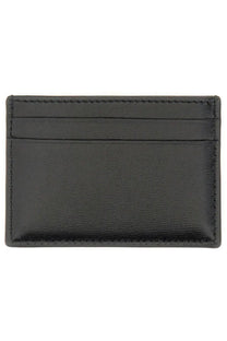 Alexander McQueen women’s black leather card holder with precise stitching along the edges