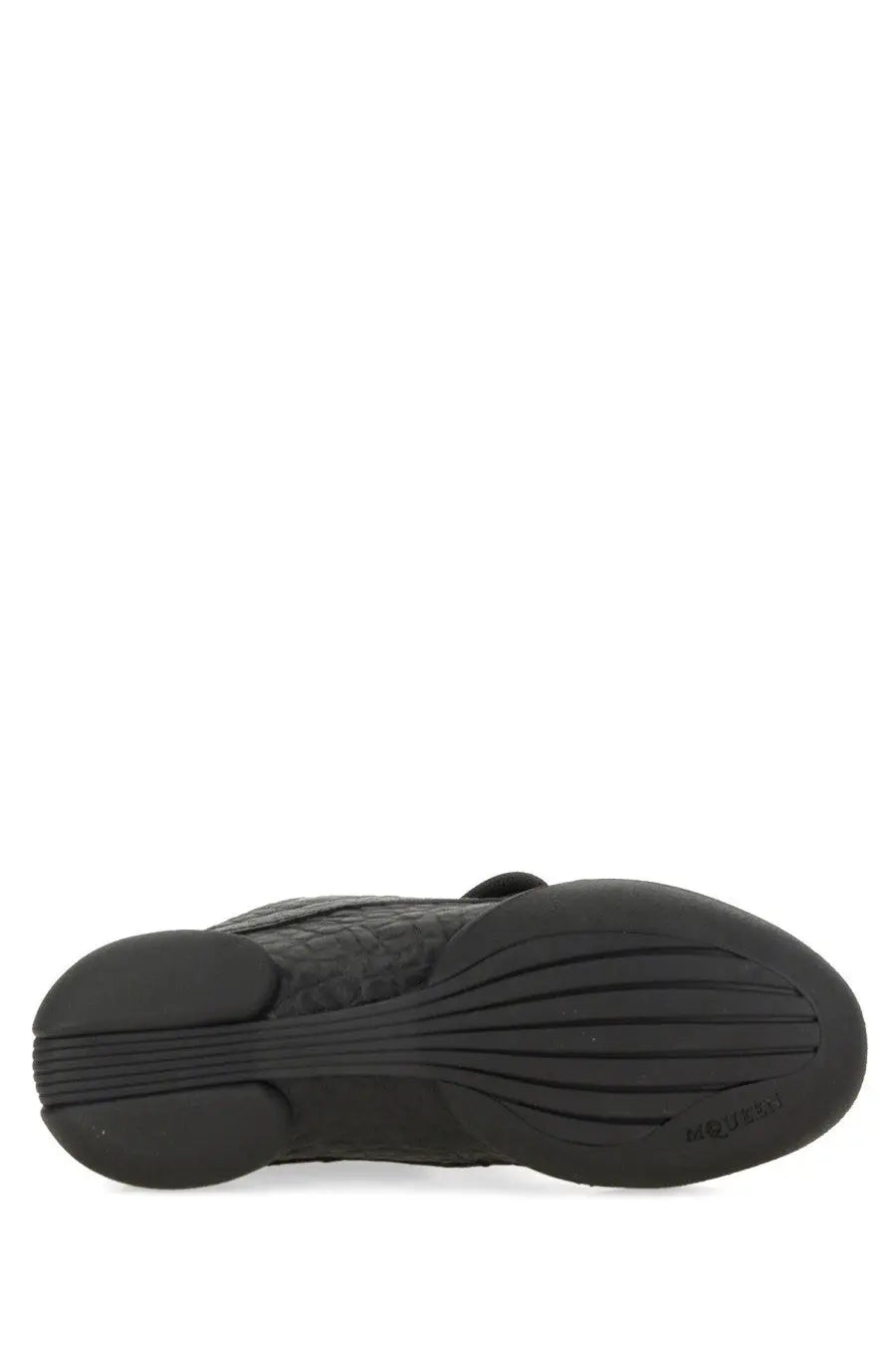 Black rubber sole with textured tread and embossed marc jacobs branding on alexander mcqueen women’s flexion sneaker black