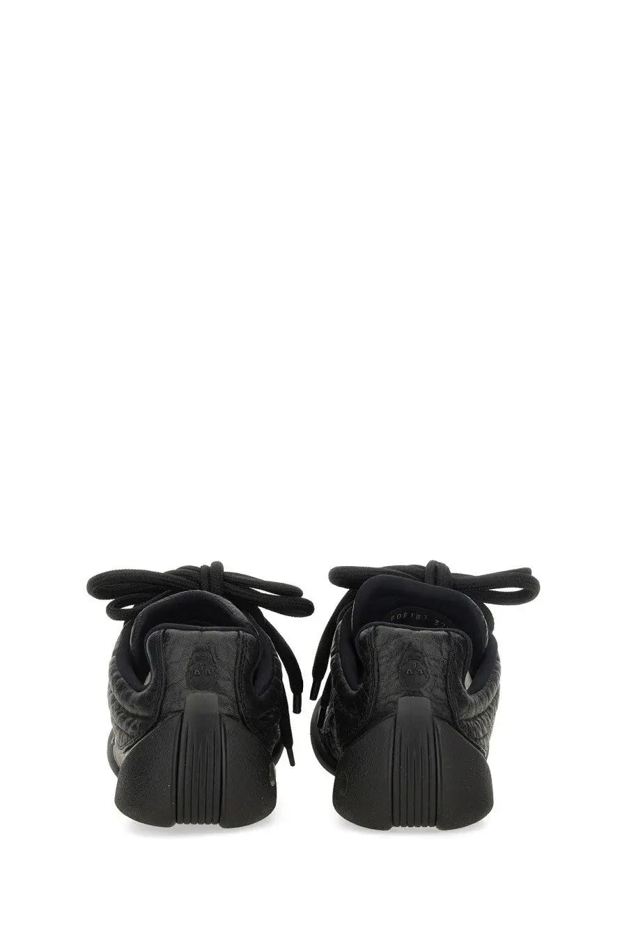 Alexander McQueen women’s Flexion sneaker black with textured upper and chunky rubber sole for stylish comfort