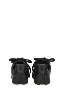 Alexander McQueen women’s Flexion sneaker black with textured upper and chunky rubber sole for stylish comfort