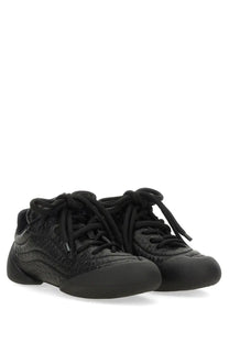 Alexander McQueen women’s flexion sneaker black with textured reptile skin upper and matching laces front view