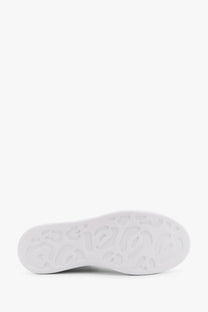 White rubber sole with embossed logo pattern on alexander mcqueen women’s larry low top leather sneakers white