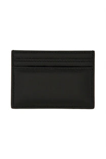 Black leather Alexander McQueen women’s card holder with precise stitching and sleek minimalist design
