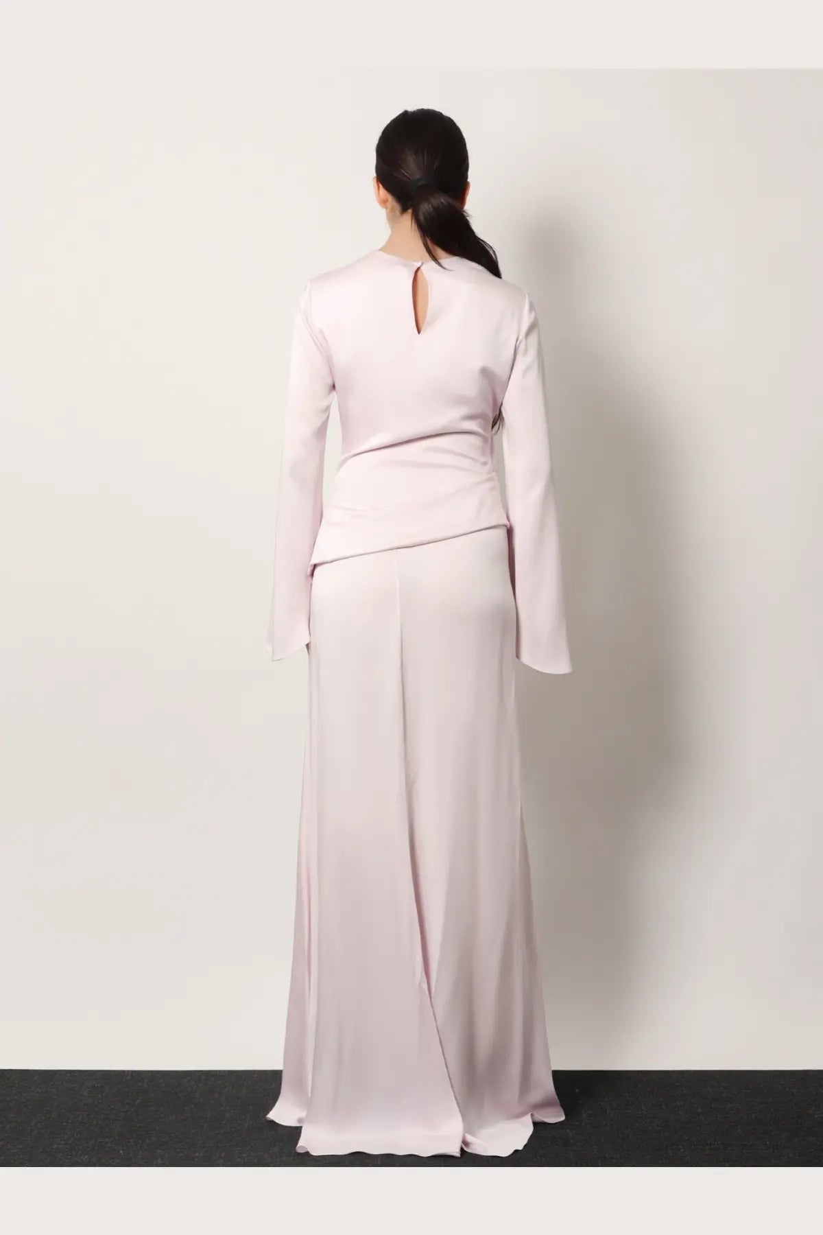 Alexander McQueen women’s blue satin long dress with long sleeves and a back keyhole detail shown from the back