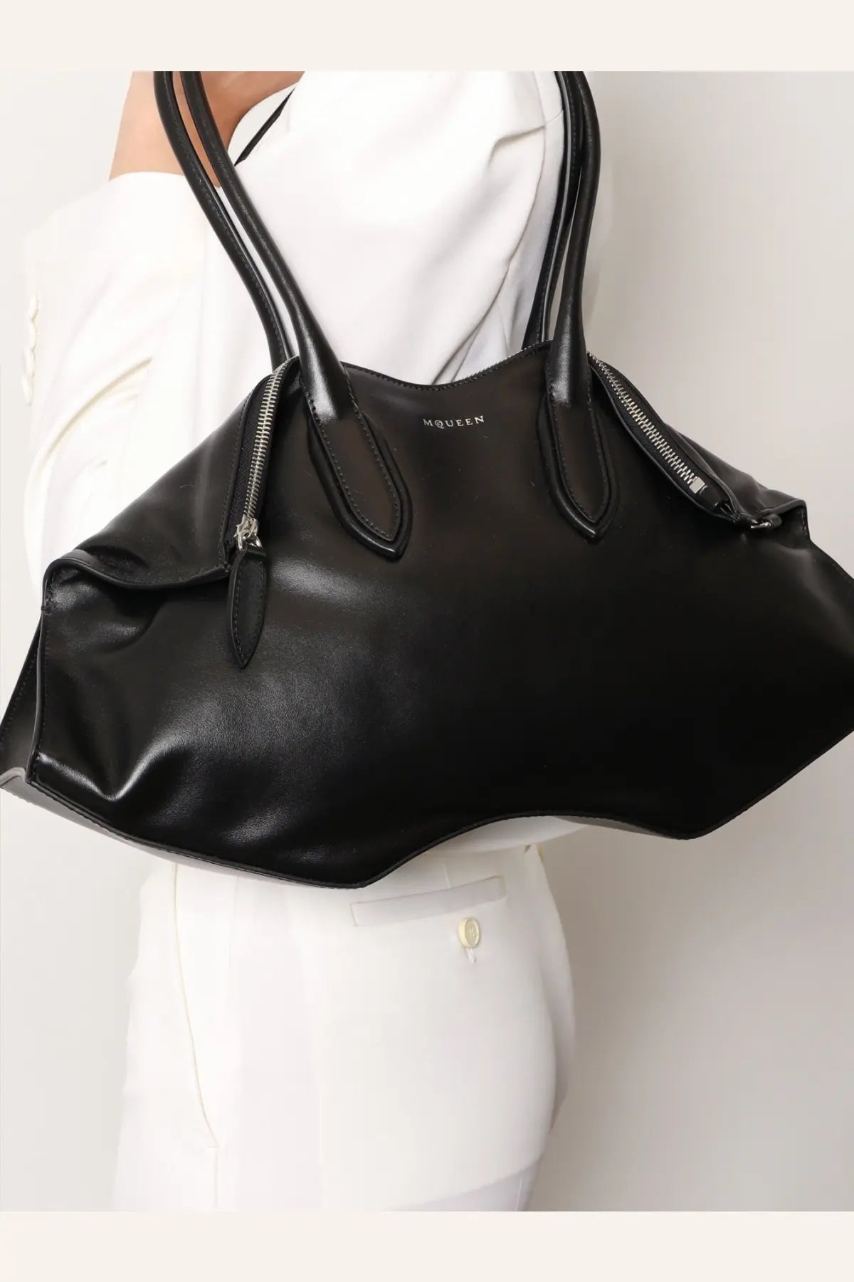 Alexander McQueen women’s manta black leather handbag with structured handles and zipper details