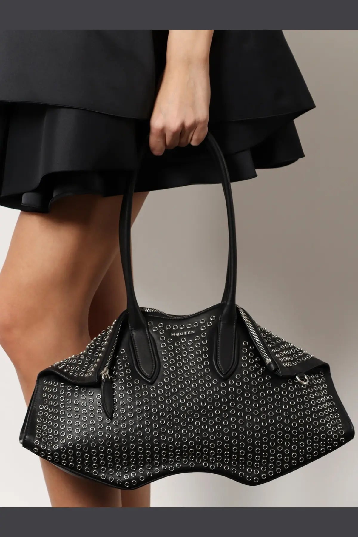 Alexander McQueen women’s manta leather shoulder bag black with silver-toned circular studs and structured silhouette