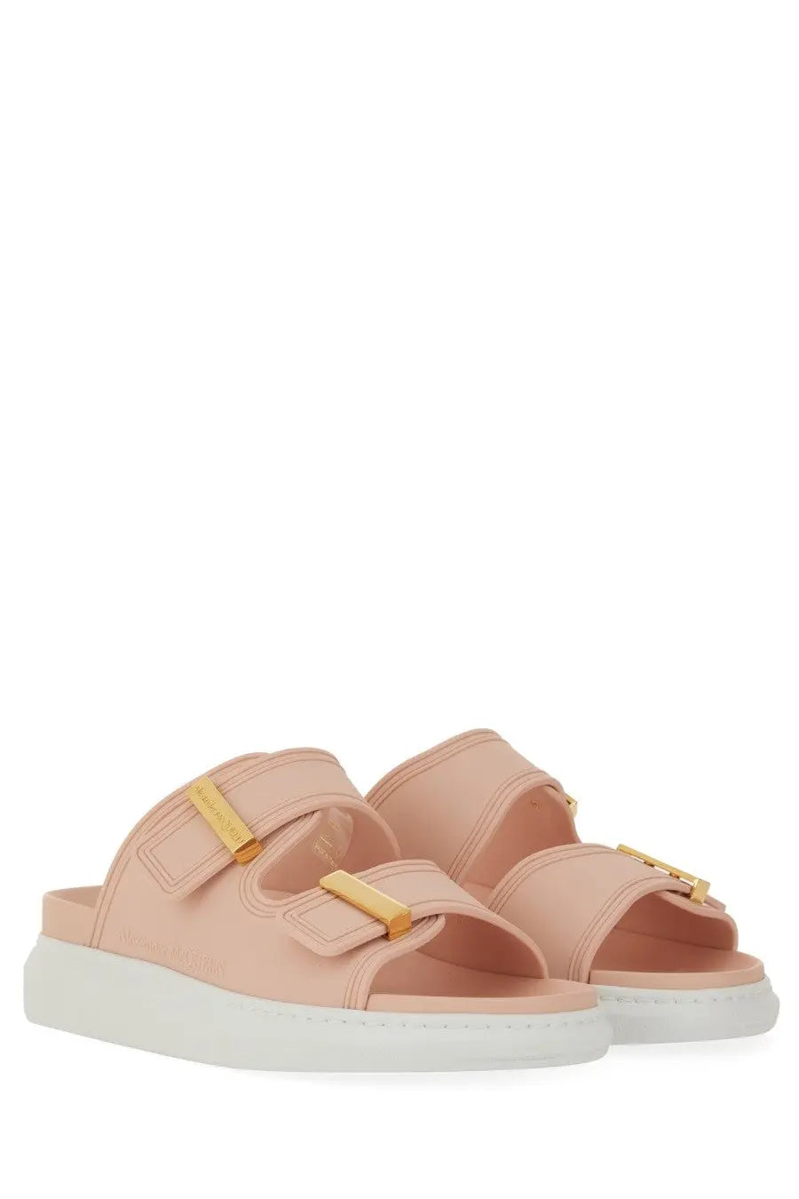Pink leather slide sandals with gold-tone buckle straps and white platform sole by alexander mcqueen
