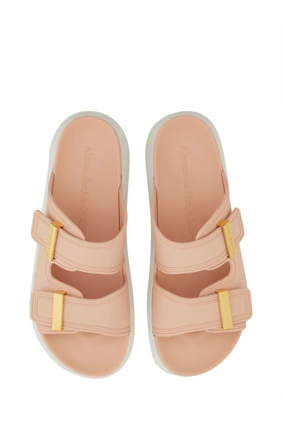 Pink leather slide sandals with gold-tone buckle straps and white rubber sole for women by Alexander McQueen