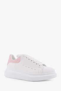 White leather alexander mcqueen women’s oversize sneaker with pink suede heel tab and chunky white sole back view