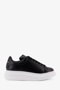 Black leather alexander mcqueen women’s oversized sneaker with thick white rubber sole and black laces