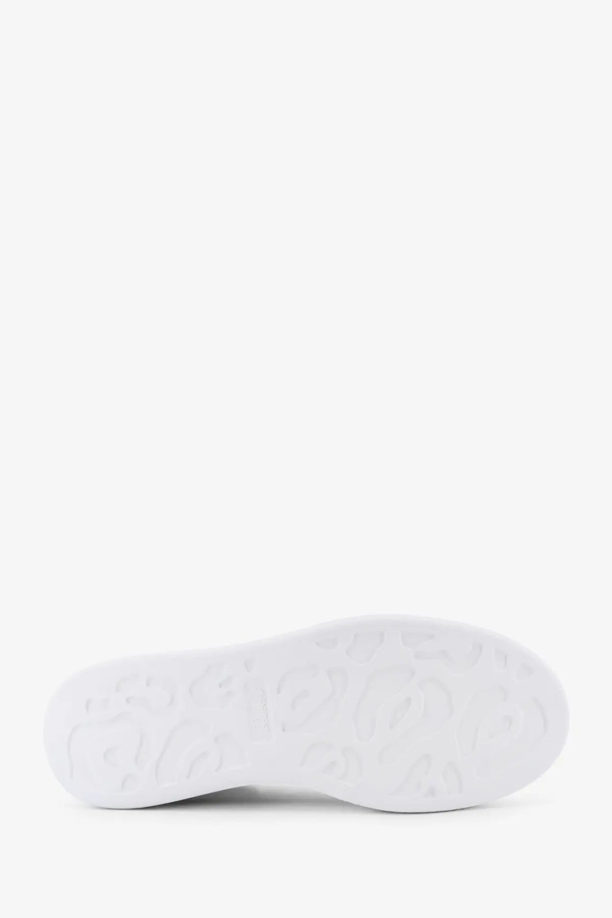 White rubber sole with embossed logo pattern on alexander mcqueen women’s oversized black leather sneakers back side