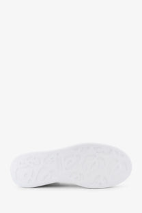 White rubber sole with embossed logo pattern on alexander mcqueen women’s oversized black leather sneakers back side