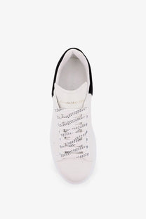 Alexander McQueen women’s oversized leather sneakers in white with black accents and perforated laces