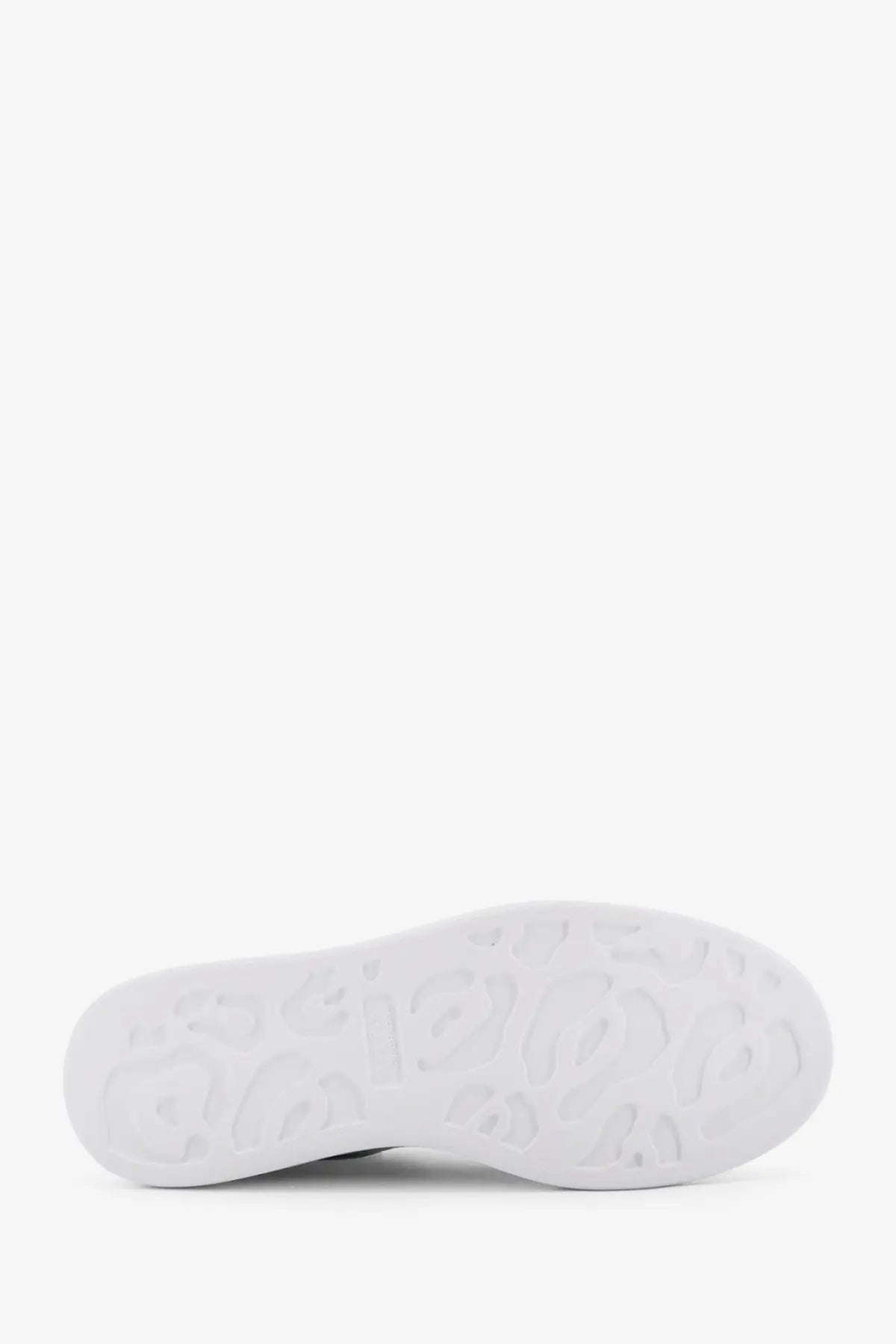 White rubber sole with embossed logo pattern on alexander mcqueen women’s oversized leather sneakers white