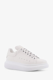 Alexander McQueen women’s oversized white leather sneakers with chunky sole and perforated detailing