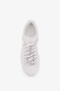 Alexander McQueen women’s oversized white leather sneaker with perforated detailing and gold branding on the tongue